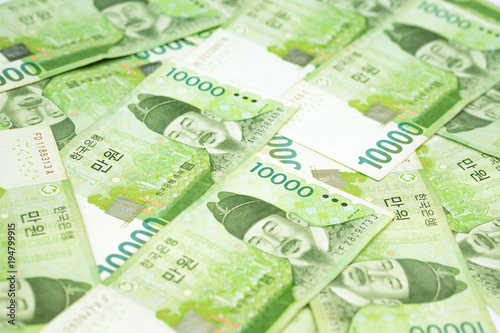 10000 Korea won bills on table as money background. South Korean Republic Won is national currency of South Korea.