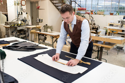 Canvas Print Tailor measuring paper pattern of jacket