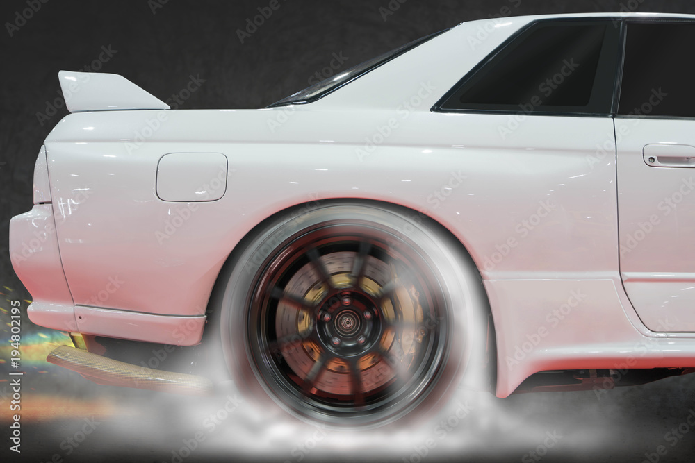 Rear wheel drive super sport car burning tire for warm up before competition to increase type temperature for good traction and grip with back fire at exhaust.