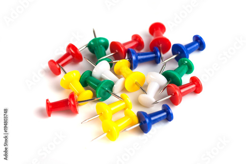 Closeup of Many Colored Thumbtacks on White