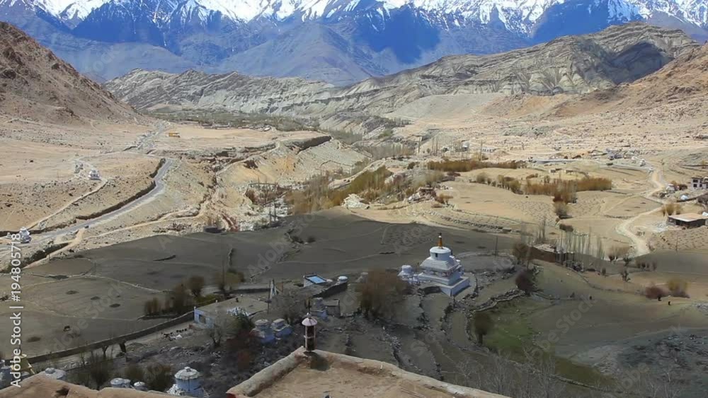 View of snowy Himalayan mountain range and a stupa in buddhist temple at Ladakh in Kashmir, India View of snowy Himalayan mountain range and a stupa in buddhist temple at Ladakh in Kashmir, India