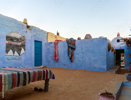 Cairo, Egypt February 18, 2017: Partial view of the central patio of a Nubian house painted blue and with drawings in a village near Cairo photo