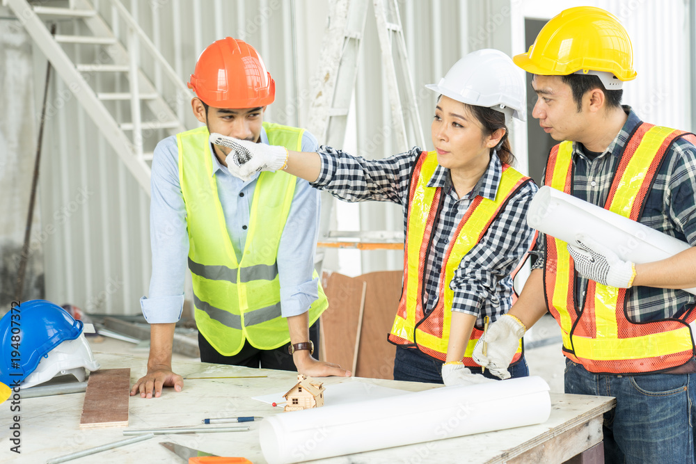 engineers visit the construction site.Examining blueprint with construction manager. engineers visit the construction site.Examining blueprint with construction manager.