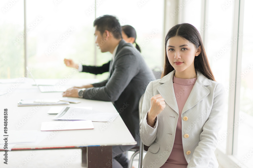 Modern business woman in the office with copy space.she sit down and smile. Modern business woman in the office with copy space.she sit down and smile.