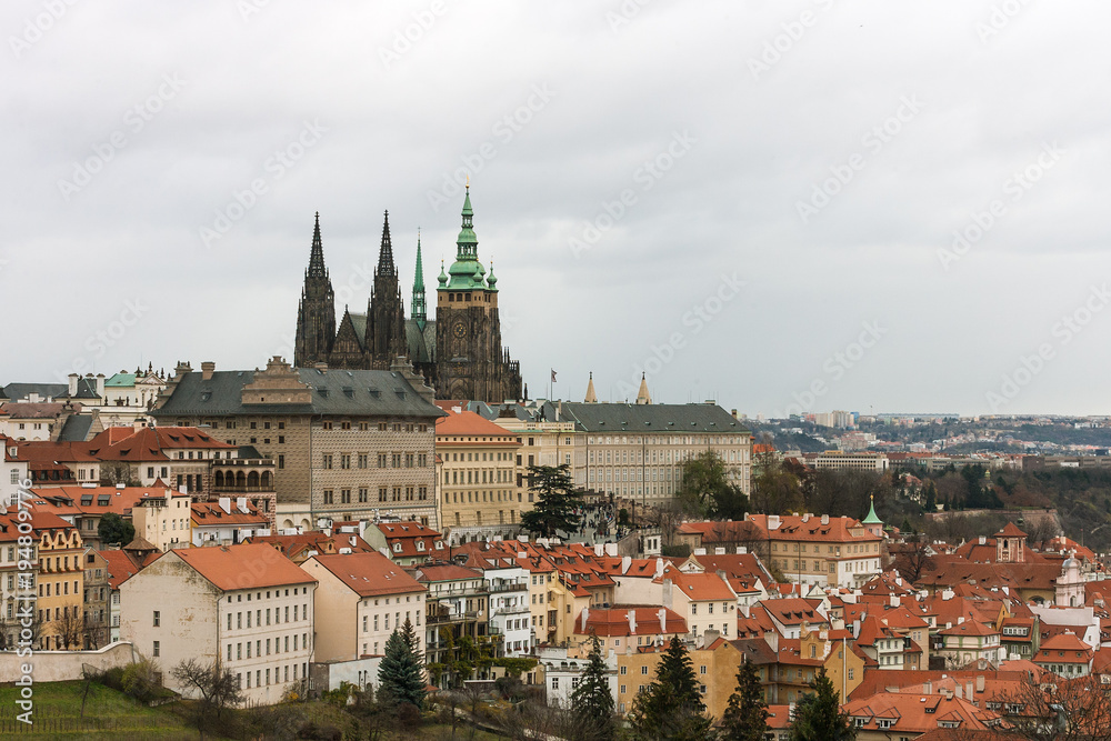 Skyline of Prague old houses and St. Vitus Cathedral. View from Petrin hill park, Czech Republic