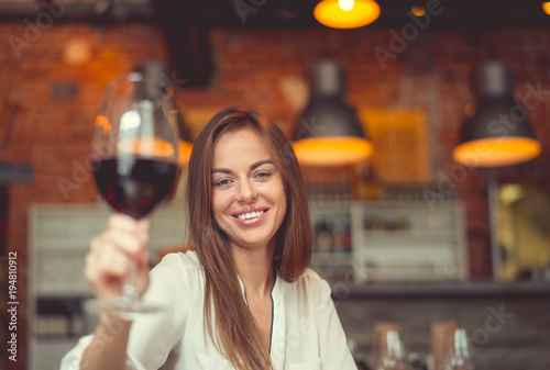 Young smiling girl with a glass of wine