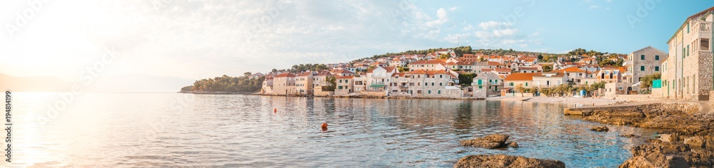 Panoramic scenery of a beautiful beach of a small town Postira - Croatia, island Brac Panoramic scenery of a beautiful beach of a small town Postira - Croatia, island Brac