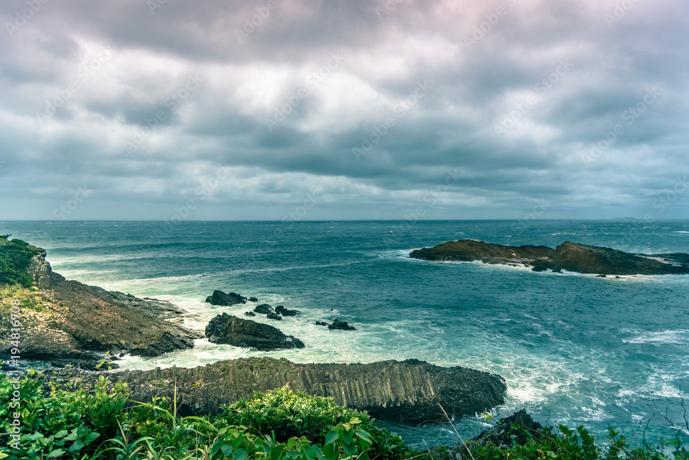 Naklejka premium Wild waves crashing on rocks in the sea at Tsumekizaki Park near Shimoda, izu peninsula, Japan