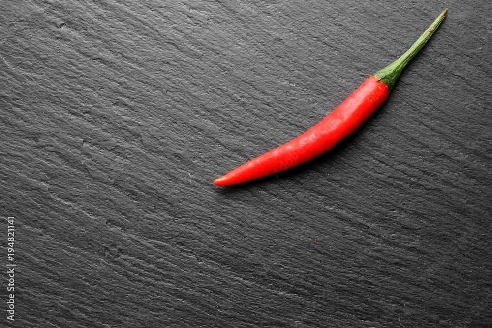 Red chili pepper on slate board Red chili pepper on slate board