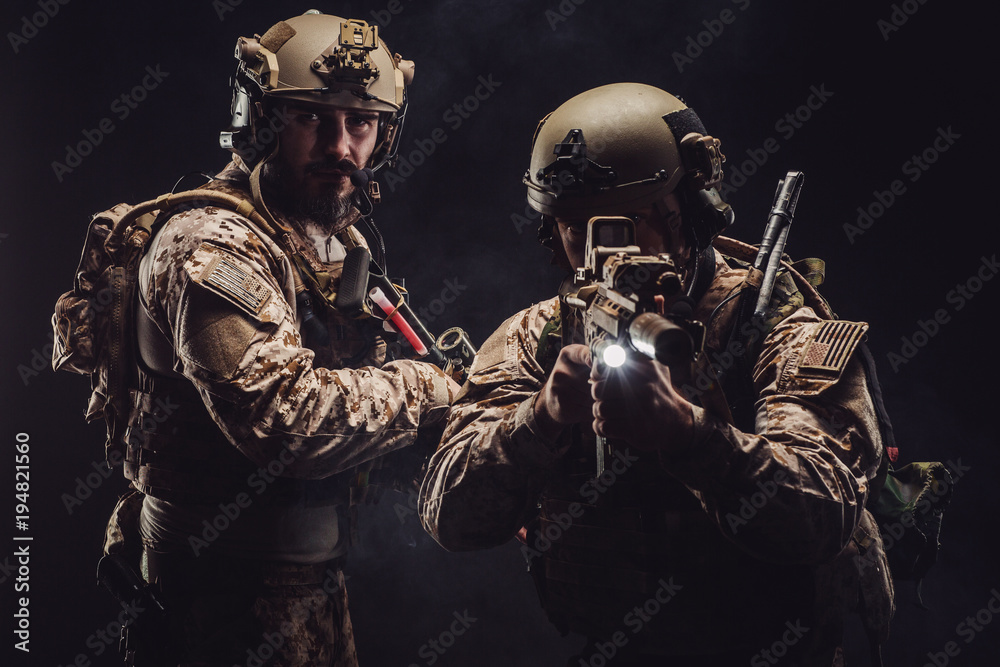 soldiers or private military contractors holding rifle. Image on a black background. war, army, weapon, technology and people concept soldiers or private military contractors holding rifle. Image on a black background. war, army, weapon, technology and people concept