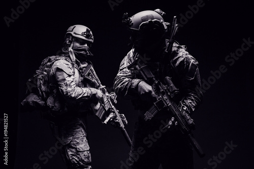 Photography soldiers or private military contractors holding rifle