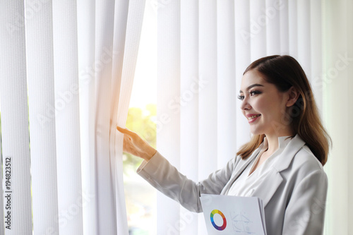 businesswoman stand near office window with financial marketing profit chart success growing up document from mathematics design business strategy in global investment. Opening new chance © Auttapon Moonsawad