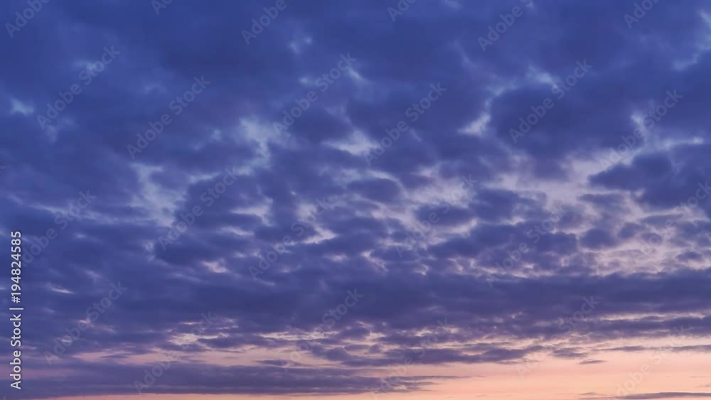 Red and yellow light of rising sun suffuses dark blue clouds at morning Red and yellow light of rising sun suffuses dark blue clouds at morning