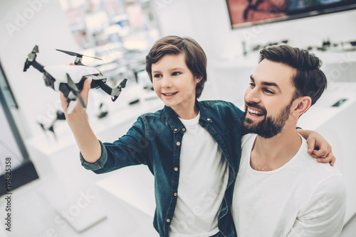 Dad and son in quadcopter store