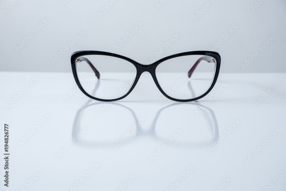 black glasses on white table