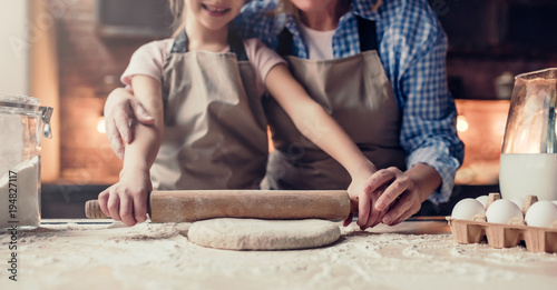 Grandmother and granddaughter cooking on kitchen