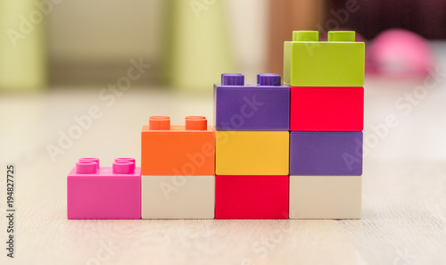 Bar chart created from toys. Conceptual image symbolizing things are on the rise, increasing, made from toys.