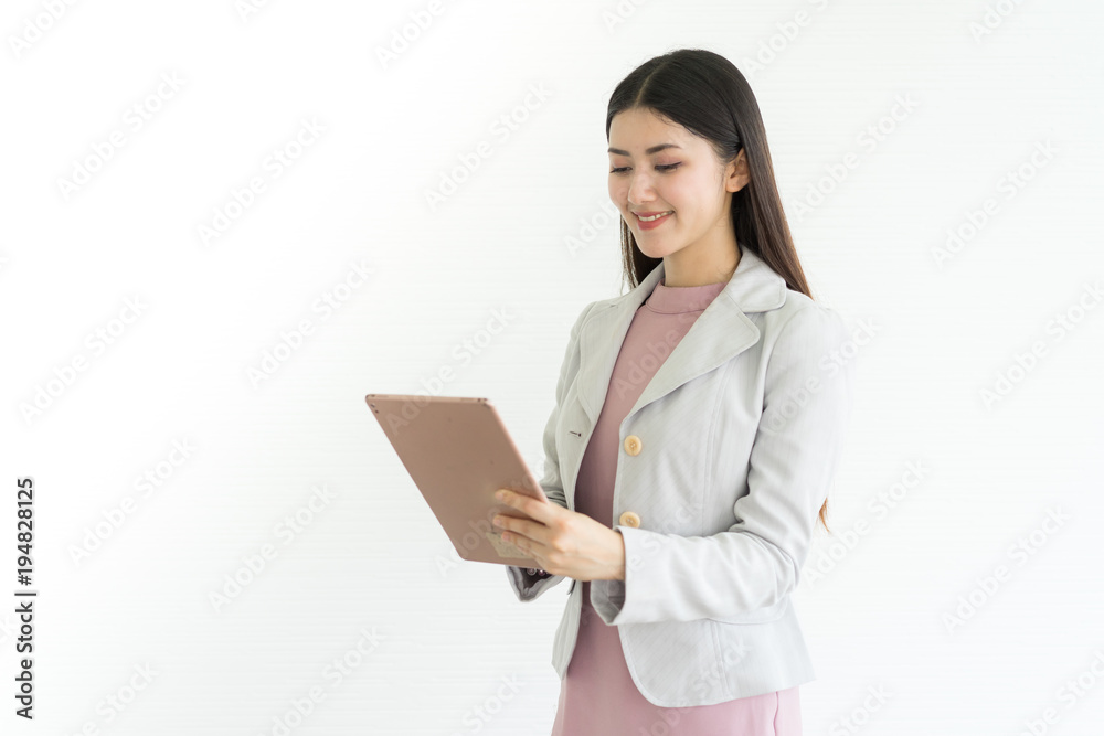 Modern business woman in the office with copy space.she hold tablet and stand front white background. Modern business woman in the office with copy space.she hold tablet and stand front white background.
