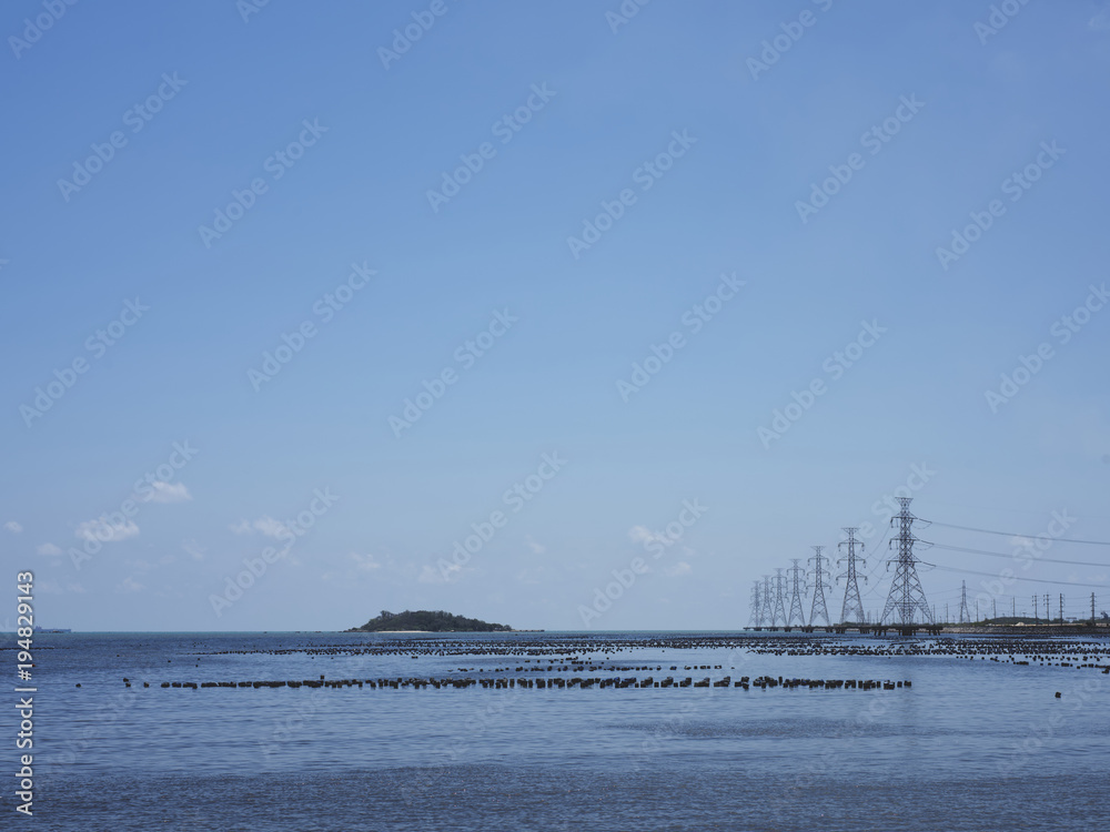 High voltage power pole in the sea and sky background.transmission tower.Electricity pylon
