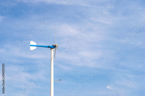 Wind turbine with blue sky and clouds, renewable energy, generate electricity