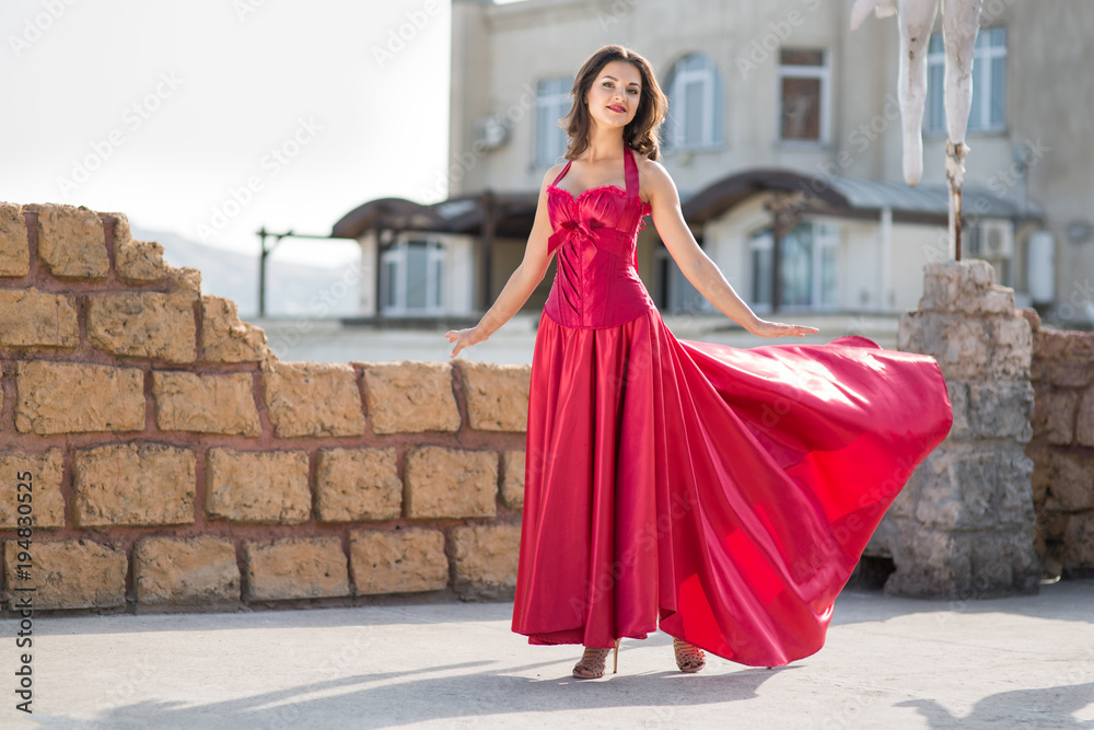 Fototapeta premium Beautiful woman in a red dress