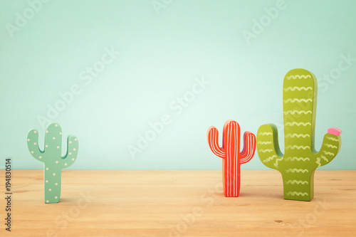 Fototapeta Image of colorful cactus decoration infront of wooden blue background.