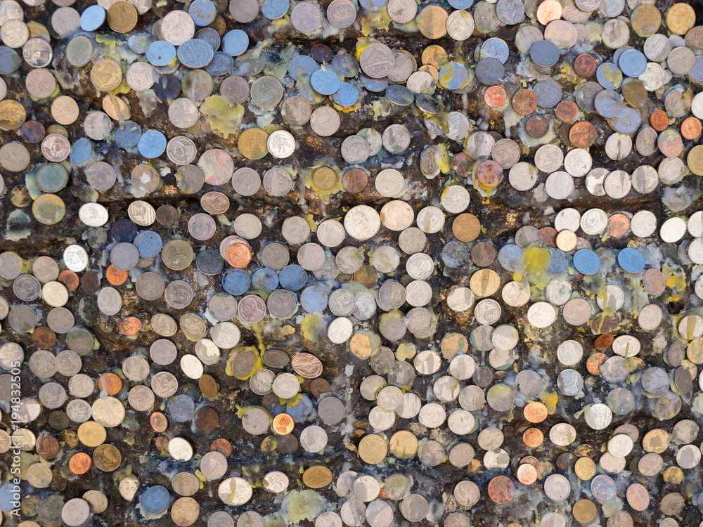 Many coins stick on board with candle tears at Doi Suthep, Chiangmai, Thailand Many coins stick on board with candle tears at Doi Suthep, Chiangmai, Thailand