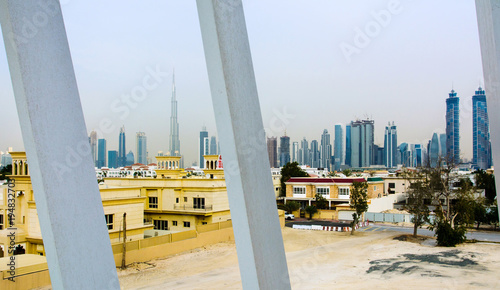 View of Dubai through the water canal bridge photo