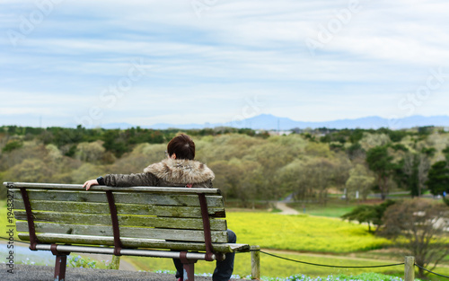 One person sitting on bench in the park, , Hitachi Seaside Park, Japan © YUU-ME