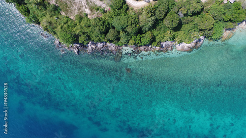 Fototapeta Naklejka Na Ścianę i Meble -  Aerial drone view of beautiful island coastline with rocks and transparent sea water around in sunny summer day