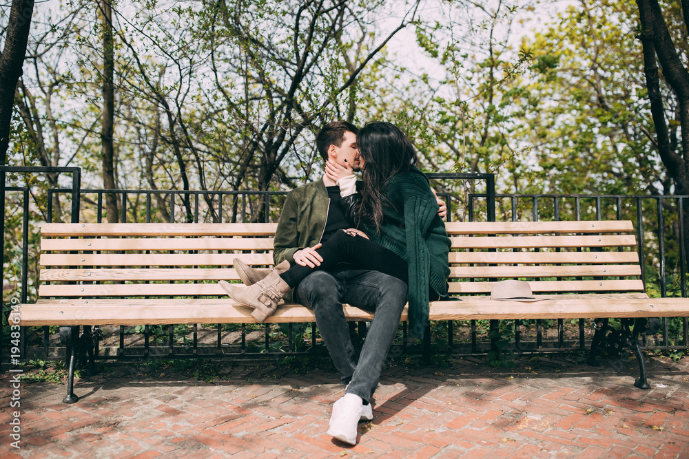 Spring photo session of a beautiful young couple in the old courtyards of the city.