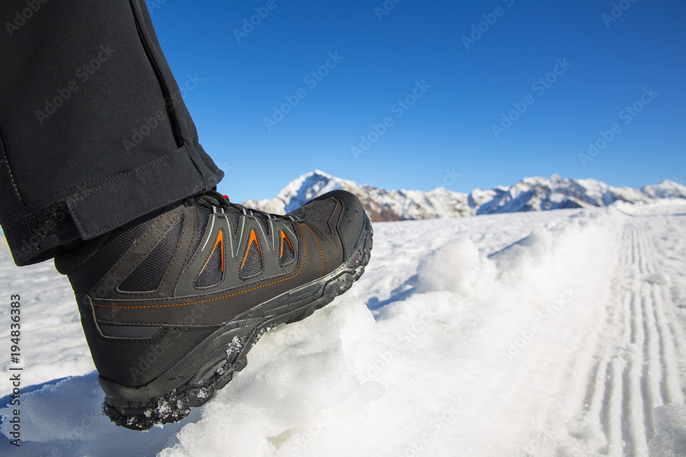 Fototapeta premium A hiker's boot on the snow