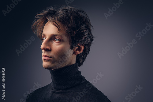 Close-up portrait of a charismatic sensual male in a black sweat
