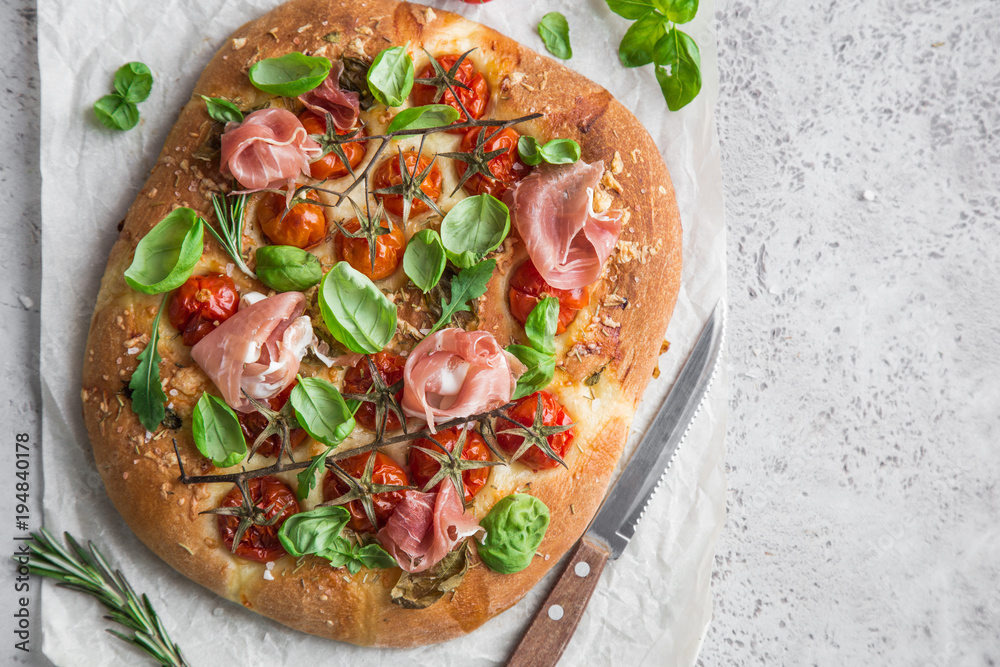 Photography italian bread focaccia with prosciutto,tomatoes, basil and sea salt