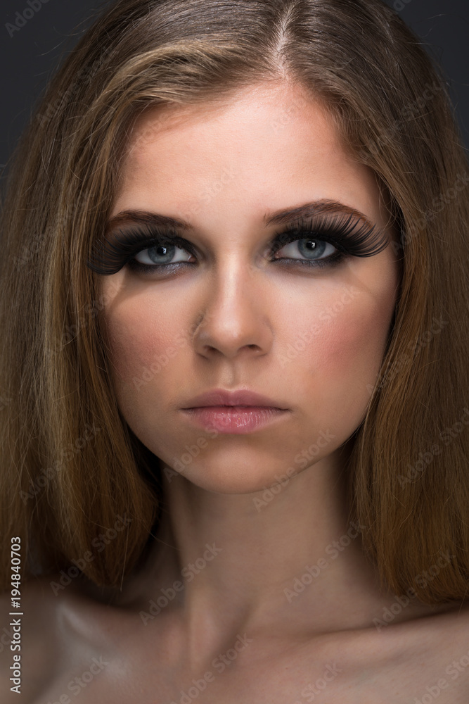 Bright cosmetics on young women and black lips Bright cosmetics on young women and black lips
