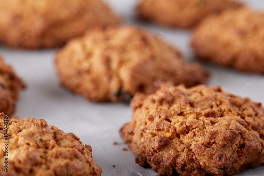Sweet biscuits arranged in pattern on light textured background, close-up, shallow depth of field, selective focus.