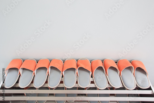 Shoes on the shelves in the hallway in the house for the whole family.