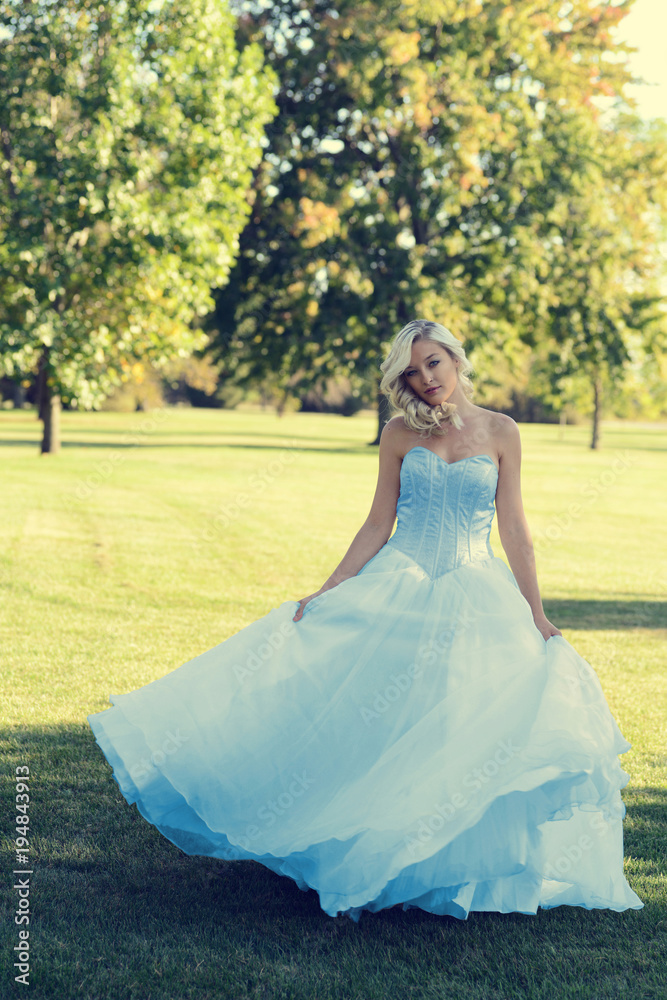 woman in blue tulle dress dancing in the park woman in blue tulle dress dancing in the park