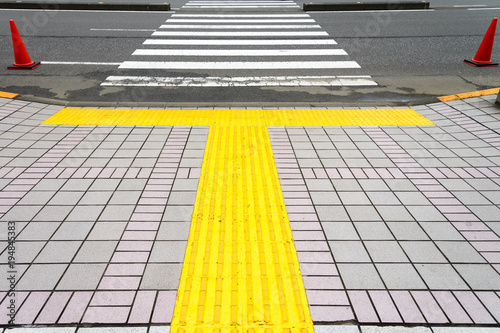 Photography Pavement with Yellow line step for blind waiting standing on the crosswalk, toky