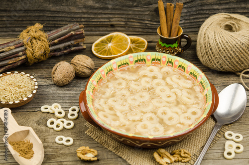 Romanian traditional food called mucenici. Eight shape made from flour, cooked and served with sugar, walnuts and cinnamon photo