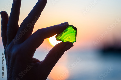 sea smoothed green glass in hand
