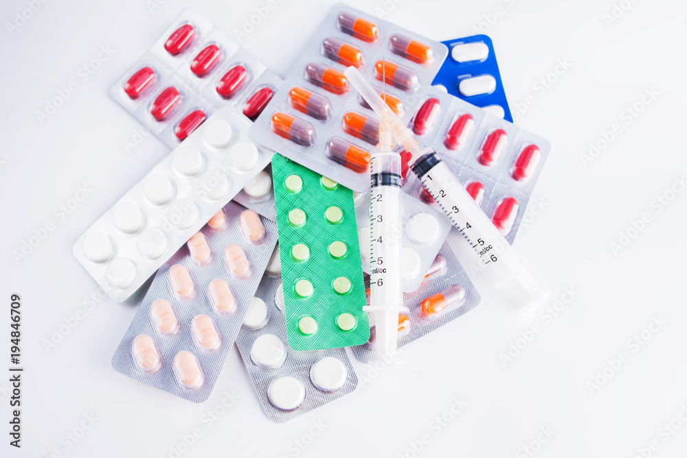 syringe and pills isolated on white syringe and pills isolated on white