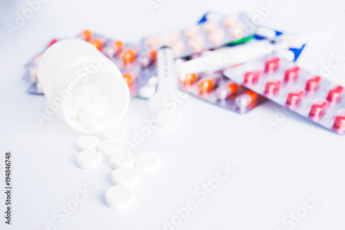 syringe and pills isolated on white