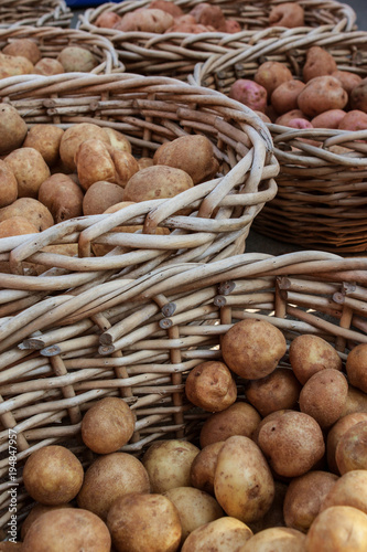 Potatoes In Wicker Baskets Sit On Sale At Farmers Market
