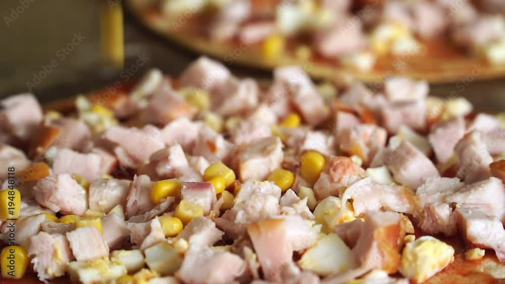 Slow motion of canned corn grains fall on pizza Slow motion of canned corn grains fall on pizza
