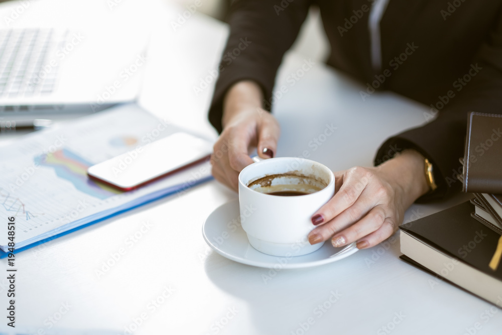 young beautiful asian business woman taking a coffee break