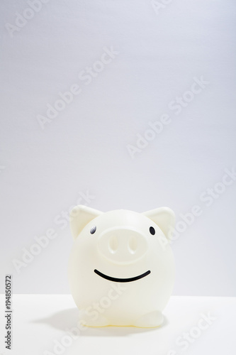 Smile Piggy bank on white desk for imaging to bright 