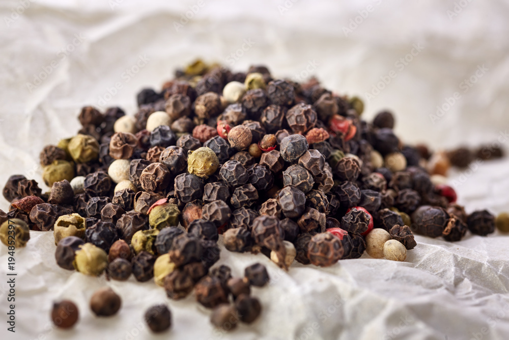 black pepper peas on a wooden spoon black pepper peas on a wooden spoon