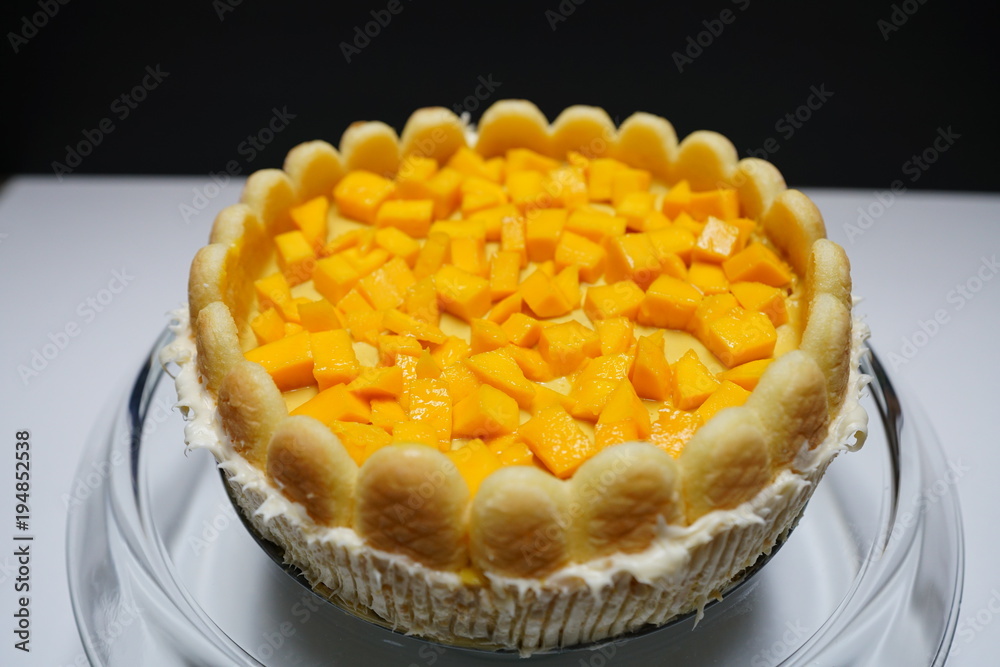 Homemade mango cake with cookies around the edge. Homemade mango cake with cookies around the edge.