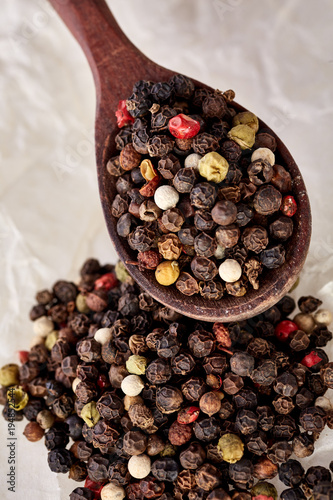 black pepper peas on a wooden spoon photo